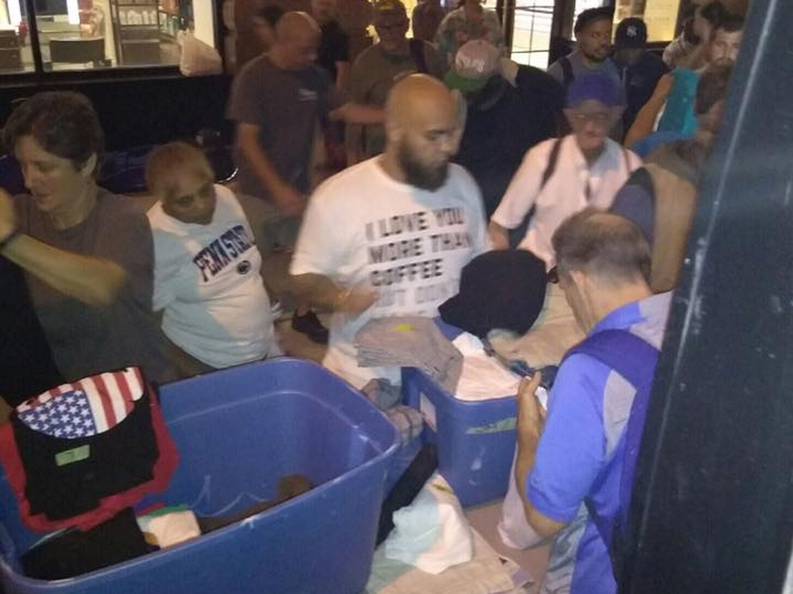 Neighbors gathering around donated clothing and goods
