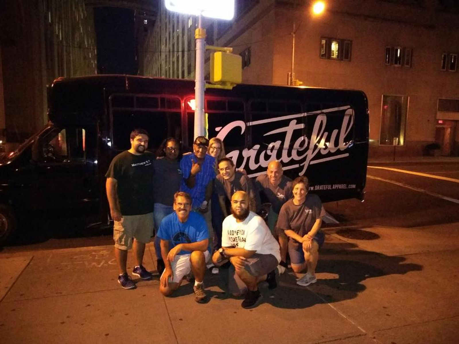 Volunteers posing with the Grateful outreach bus
